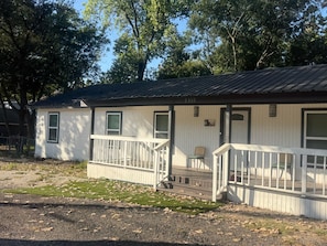 A single-story building with a porch, a small deck, and a mailbox. - 3BR Family Retreat Mini Golf Soccer Field Fire Pit (Wylie)