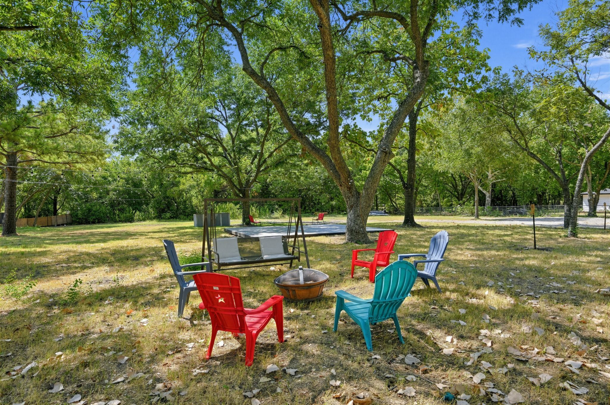 An outdoor seating area with chairs and a fire pit.