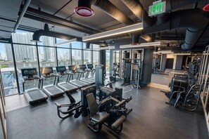 A gym with treadmills, weight machines, and exercise equipment. - Glam Miami Nightlife - Resort Pool - Downtown (Miami)