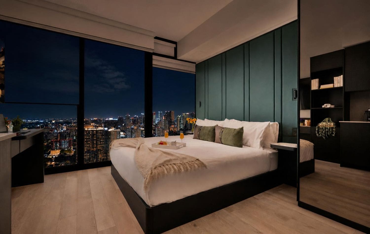 A modern bedroom with a city view, a large bed, bedside tables, and a built-in bookshelf.