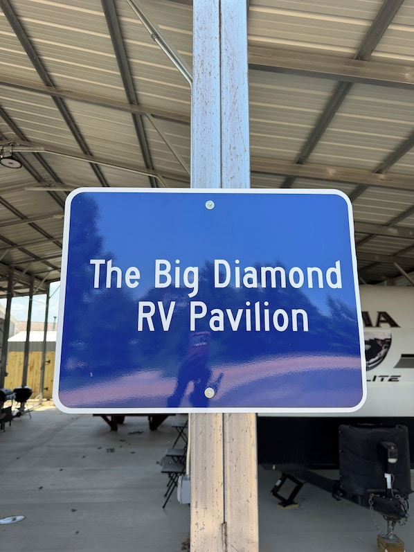 A sign with the text 'The Big Diamond RV Pavilion' indicating the name of the RV parking area.