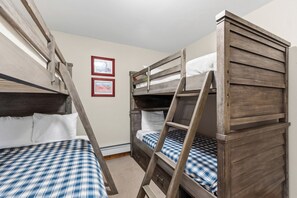 A bunk bed room with two beds, a ladder, and two framed pictures on the wall. - *EZCancel* Gold Camp Nugget - Renovated & Walking Distance to Chairlifts (Breckenridge)