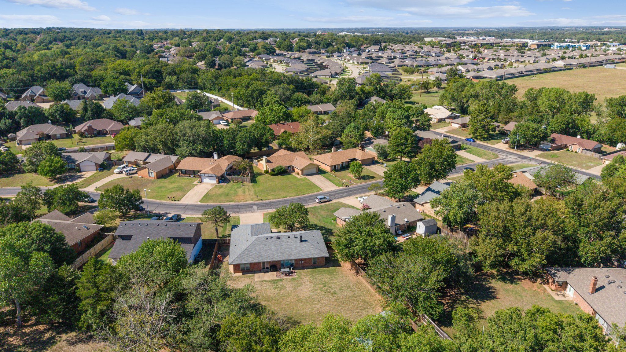 A residential area with houses, roads, and greenery.