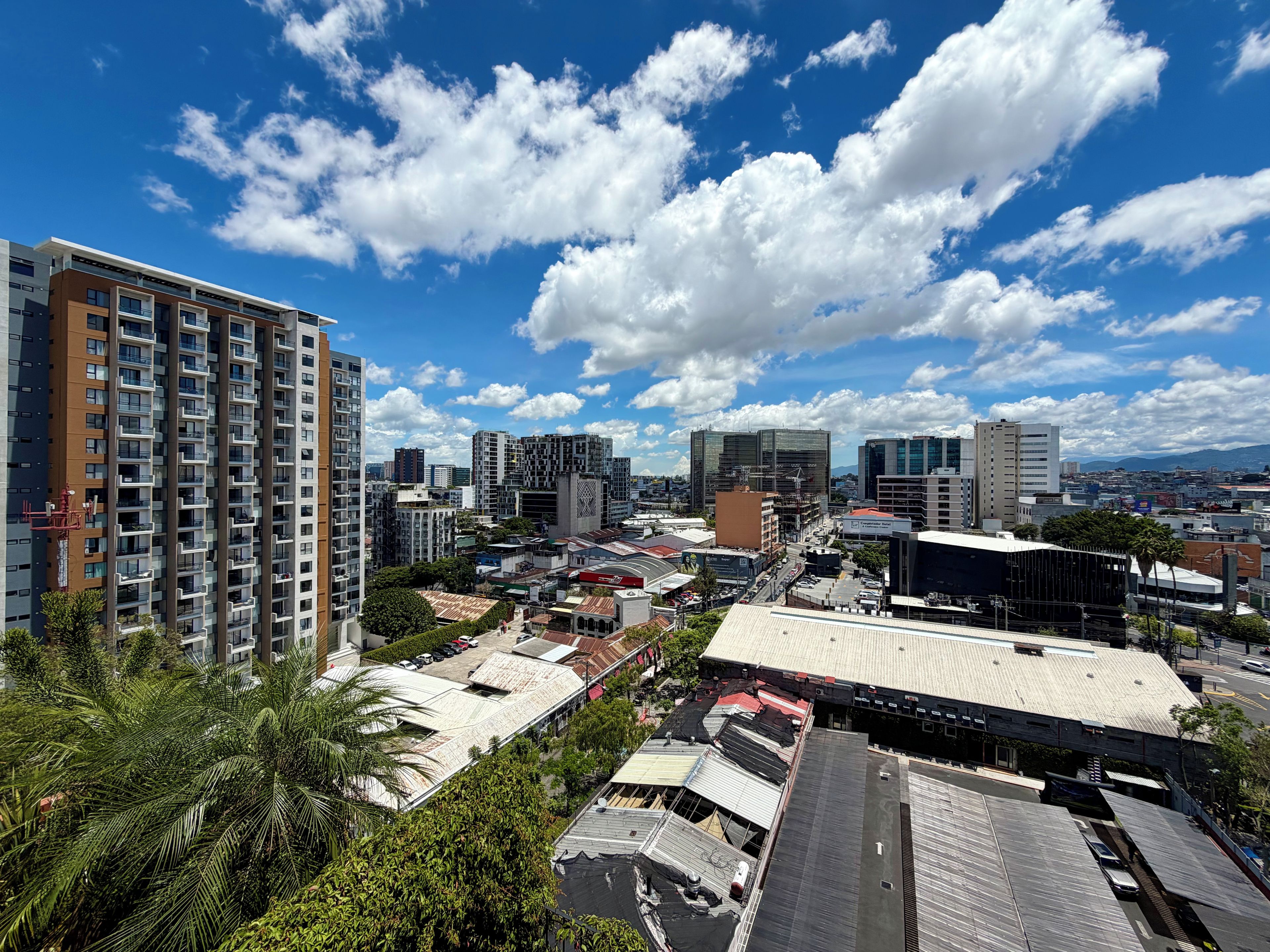 A cityscape with high-rise buildings, a clear sky, and a mix of commercial and residential structures.