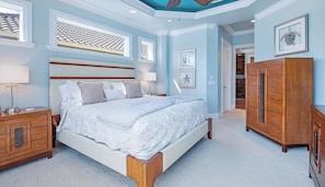 A bedroom with a large bed, wooden headboard, bedside tables, a wardrobe, and a ceiling with a decorative pattern. - Welcome to Palma Verde, a refined waterfront retreat where comfort, craftsmanshi (Marco Island)