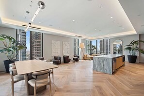 A spacious kitchen with a marble island, modern furniture, and large windows offering views of the city. - 501 First Chic Studio Balcony Downtown Miami (Miami)