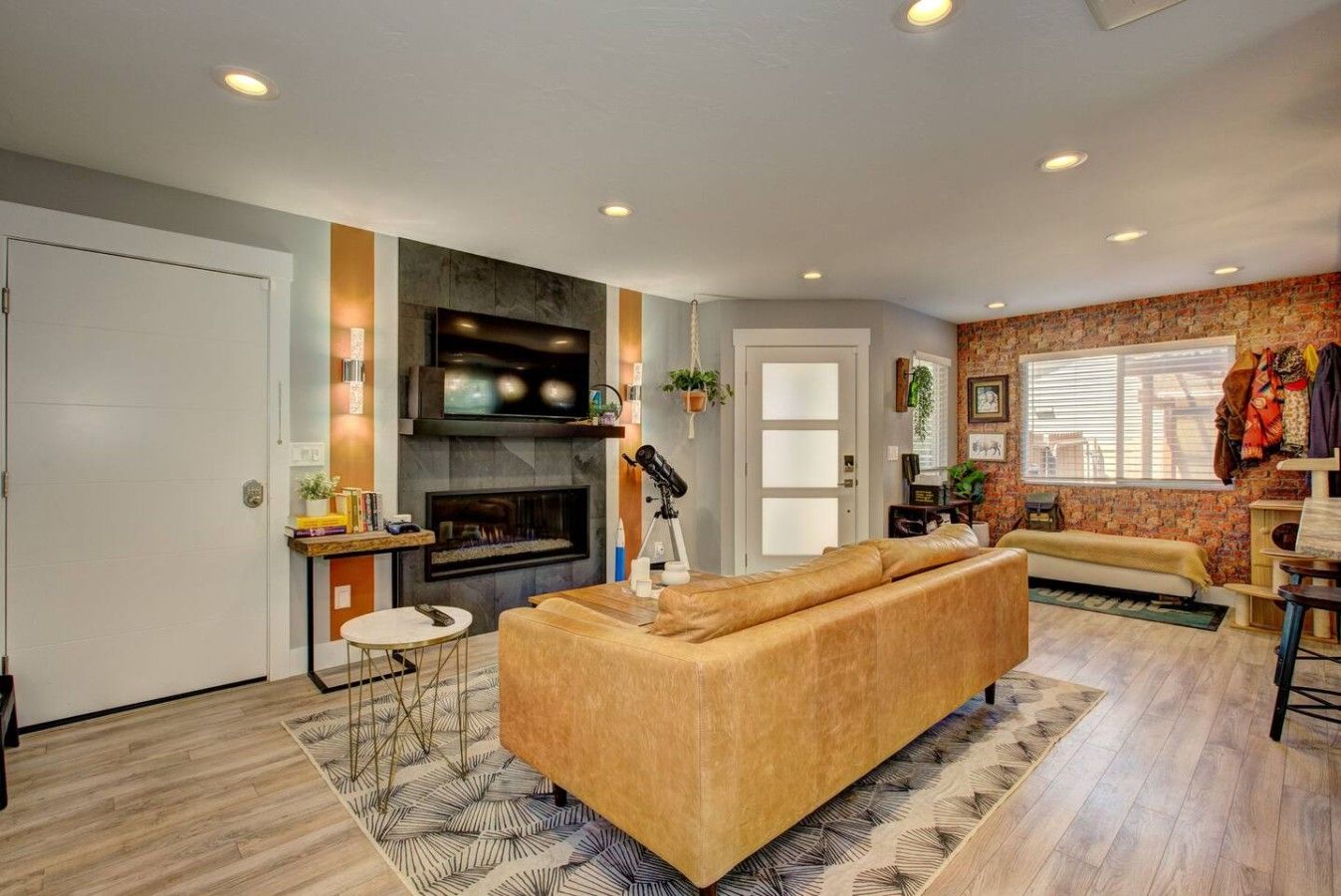 A living room with a fireplace, a sofa, a coffee table, and a TV.