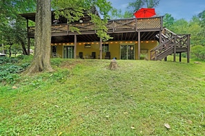 A wooden structure with a covered deck and outdoor seating area. - Entire house located on the Shenandoah River (Harpers Ferry)