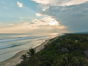 A beach with palm trees and a view of the ocean. - Private beachfront estate in the Oaxacan jungle (Puerto Escondido)