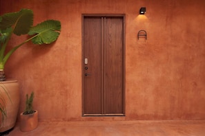 A wooden door with a handle and a small light fixture above it. - Luxury Boutique Hotel Near Downtown Oaxaca (Oaxaca de Juárez)