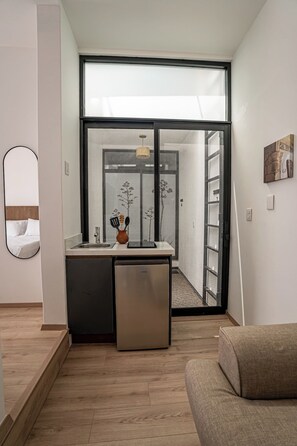 A modern kitchenette with a built-in oven, a sink, and a small refrigerator. - Laurelian 7 · Sore · Private suite near downtown (Oaxaca de Juárez)