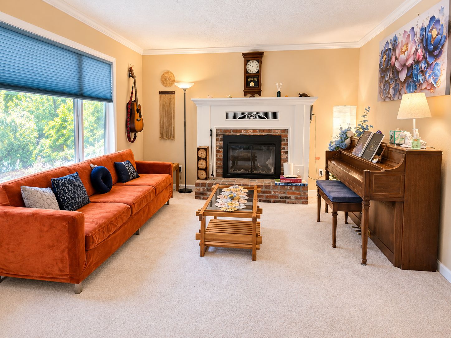 A living room with a fireplace, a sofa, a coffee table, a piano, and a clock on the wall.