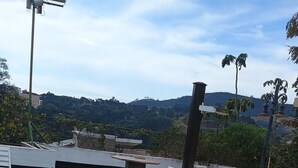 A swimming pool with a tiled edge, surrounded by a patio area with a table and chairs. - Vacation home in Serra Negra, upscale and very quiet neighborhood. (Serra Negra)