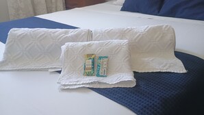 A bed with white pillows and a blue textured blanket. - Vacation home in Serra Negra, upscale and very quiet neighborhood. (Serra Negra)