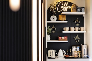 A coffee-themed display with shelves, coffee cups, and a coffee machine.