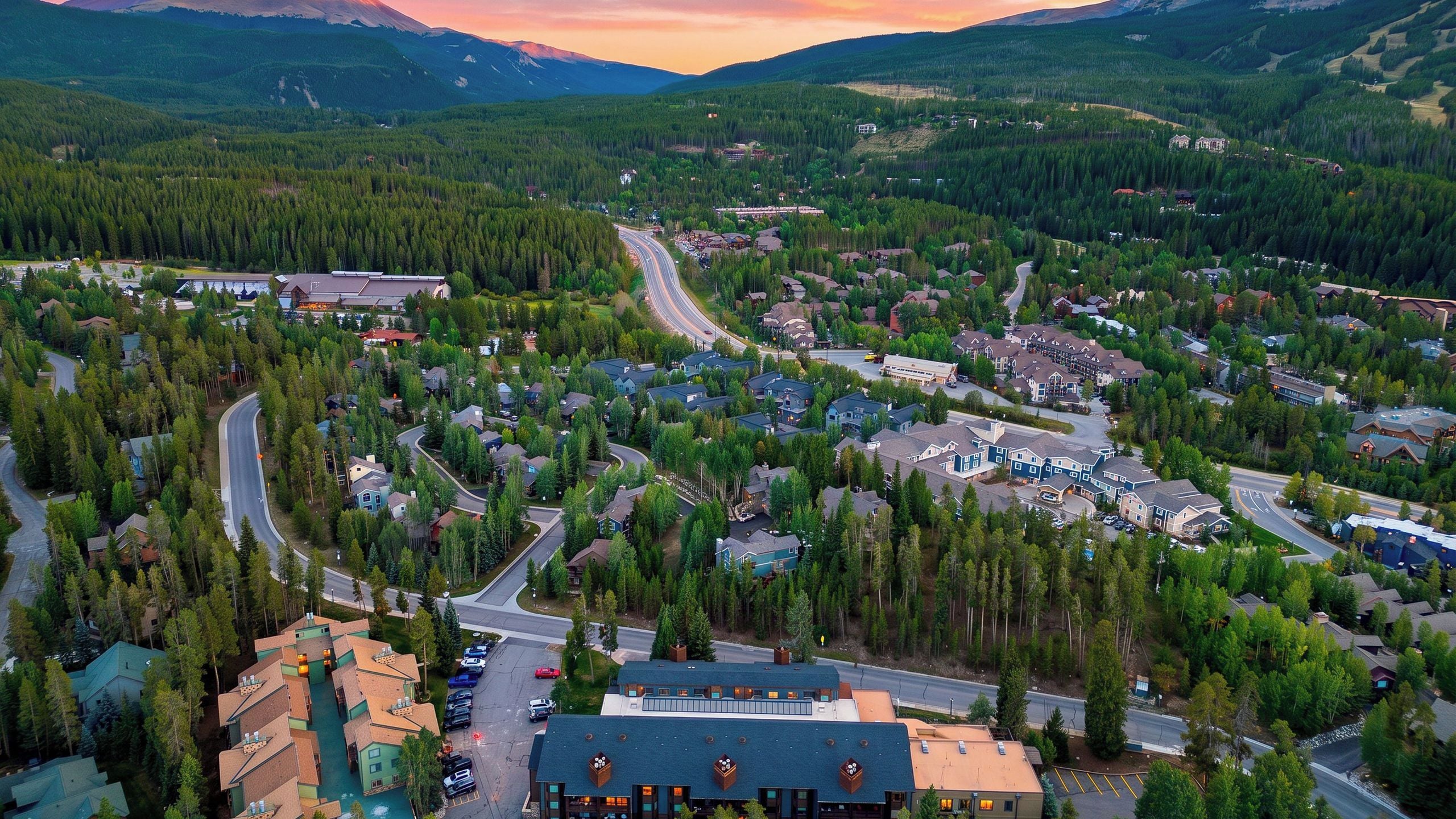 A residential area with houses, roads, and a mountain backdrop.