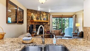 A modern kitchen with granite countertops, a stainless steel sink, and a stone backsplash. - Ski Casa Azul by Avantstay Ski Shuttle + Walk to Main St Shared Hot Tub + Grill (Breckenridge)