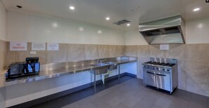 A clean, modern kitchen with stainless steel appliances, a microwave, and a gas stove.