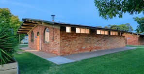 A brick building with a flat roof and a chimney, surrounded by a well-maintained lawn. - Swan Hill Lifestyle Park (Swan Hill)