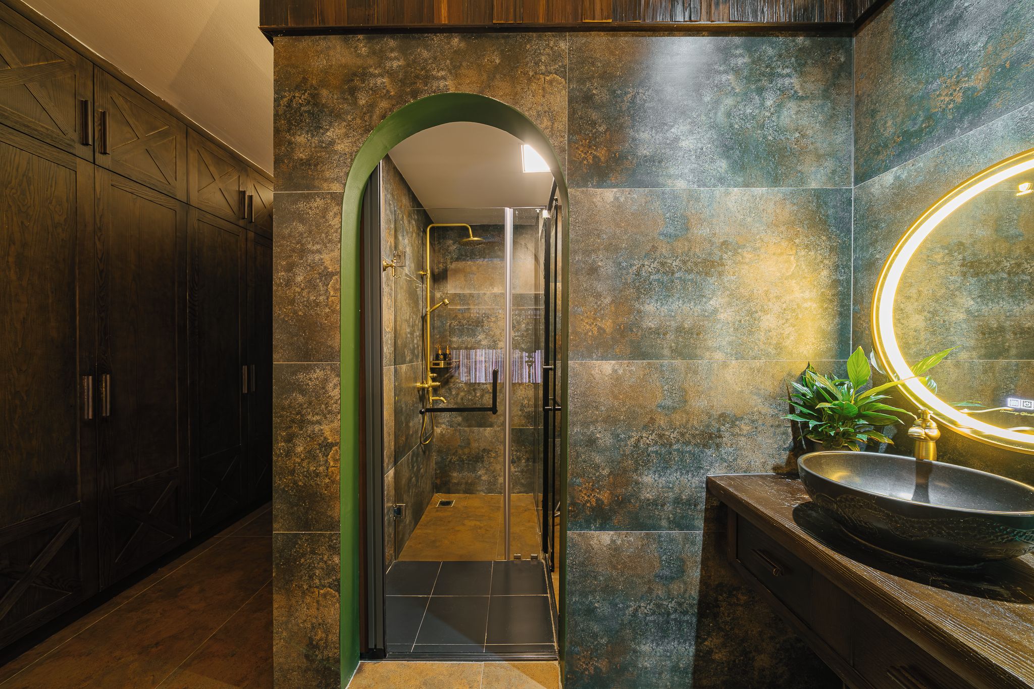 A modern bathroom with a glass-enclosed shower, a large mirror, and a wooden vanity.
