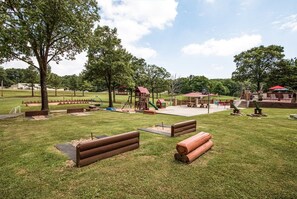A park with a playground, picnic tables, and a covered seating area. - Branson | Group Ozarks Retreat | Pools + Fitness | 3BR • Sleeps 8 (Ridgedale)