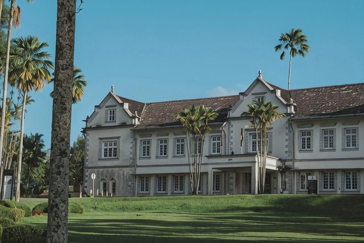 A large, multi-story building with a symmetrical facade, multiple windows, and a central entrance.