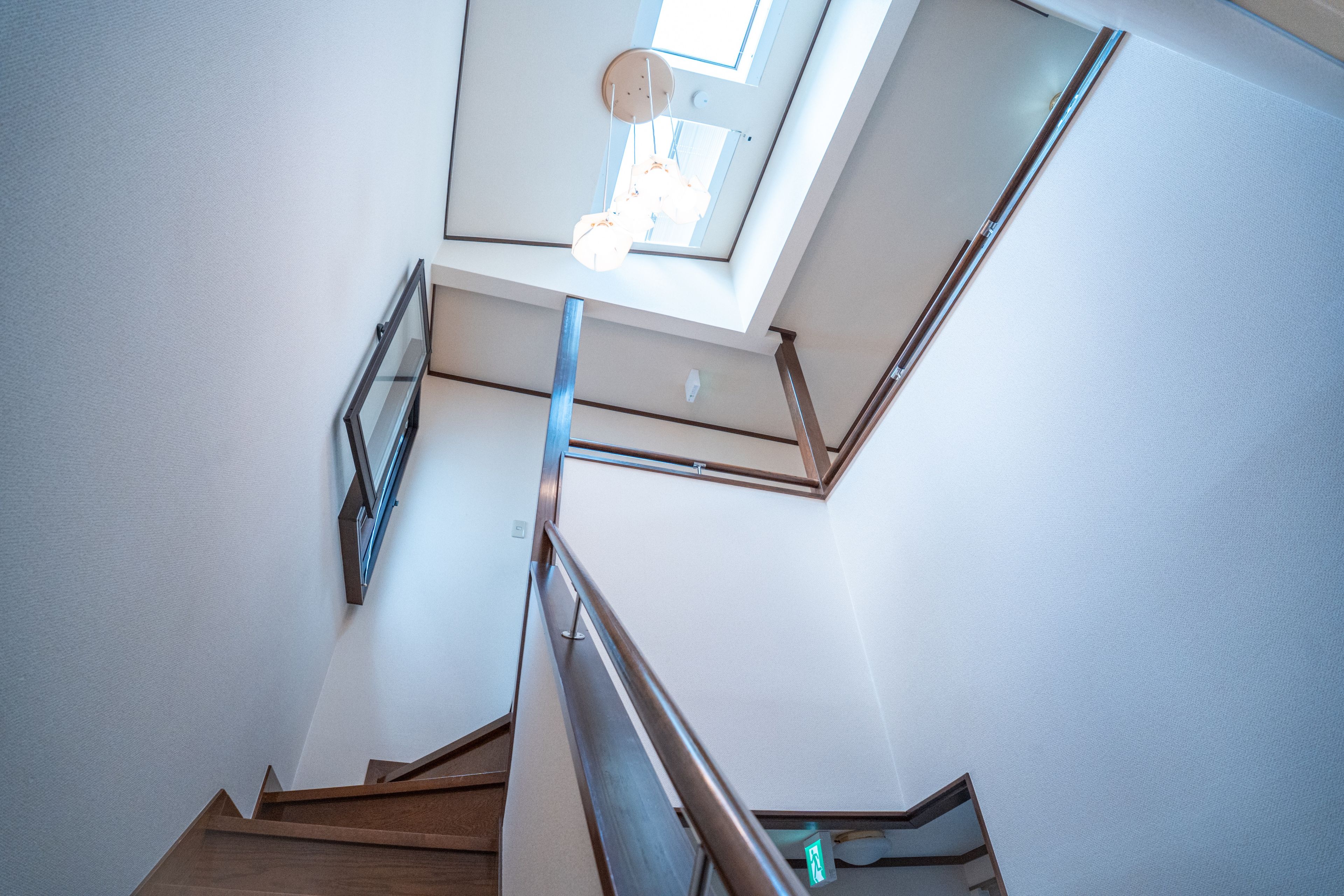 A modern interior with a staircase leading to a skylight.