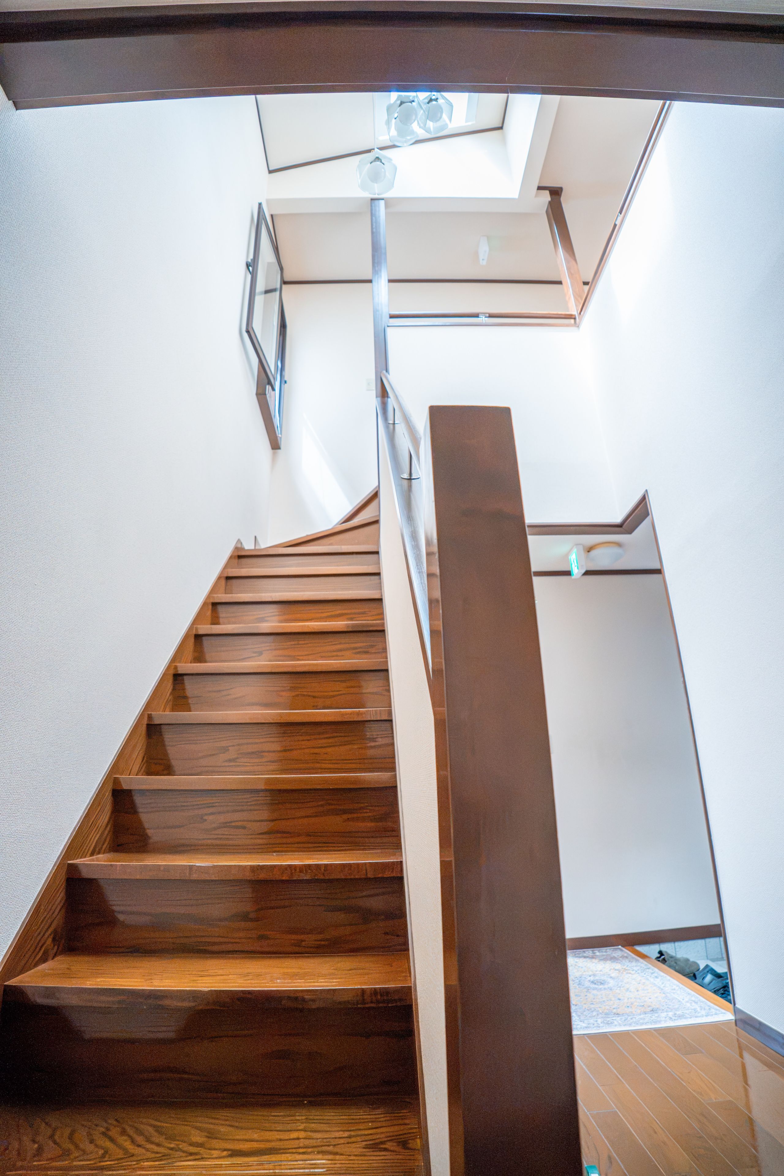 Eine Holztreppe mit Glasüberdachung und Metallgeländern.