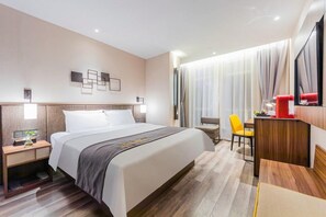 A hotel room with a large bed, a desk, a chair, a TV, and a window with curtains. - Home Inn Plus Shanghai Pudong Jinqiao (Shanghai)