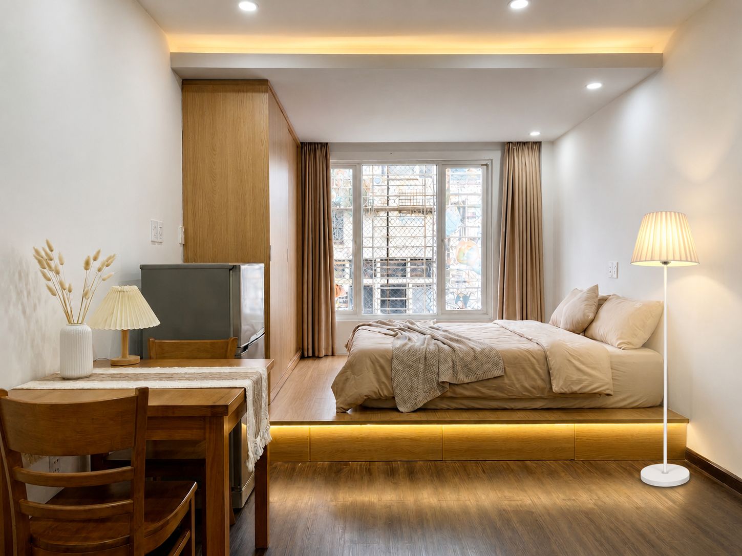 A modern bedroom with a bed, bedside table, lamp, and a view of the outside through a window.