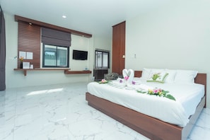 A modern hotel room with a large bed, a flat-screen TV, a window with blinds, and a marble floor.