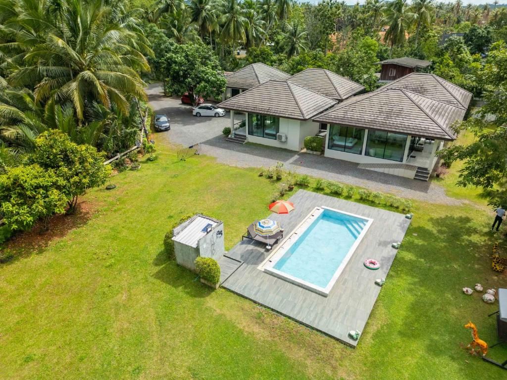 A residential property with a swimming pool, a covered patio, and a car parked outside.
