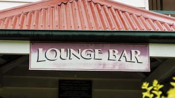 Un edificio con un letrero que dice 'LOUNGE BAR' sobre la entrada.