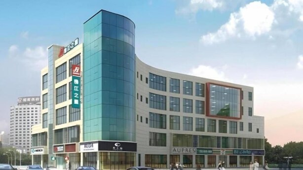 A modern hotel with multiple floors, large windows, and a prominent corner entrance. - Jinjiang Inn (Weihai)