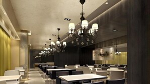 A modern dining area with multiple tables and chairs, ambient lighting, and a contemporary design. - Jinjiang Inn (Weihai)