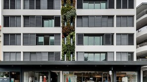 A multi-story building with a central vertical garden, large windows, and a ground-level retail space. - Guest Favourite in Bondi Beach near Shops & Cafes (Bondi Beach)