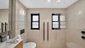 A modern bathroom with a toilet, a sink, and a shower area. - Spacious North Bondi Apt w Balcony near beach (Bondi Beach)