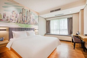 A hotel room with a large bed, a desk, a chair, a window with curtains, and a cityscape mural on the wall. - Yi Mi Hotel Luogang Jiada (Guangzhou)