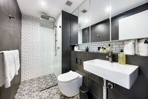 A modern bathroom with a shower, toilet, and sink. - The Albion Courtyard, Surry Hills (Surry Hills)