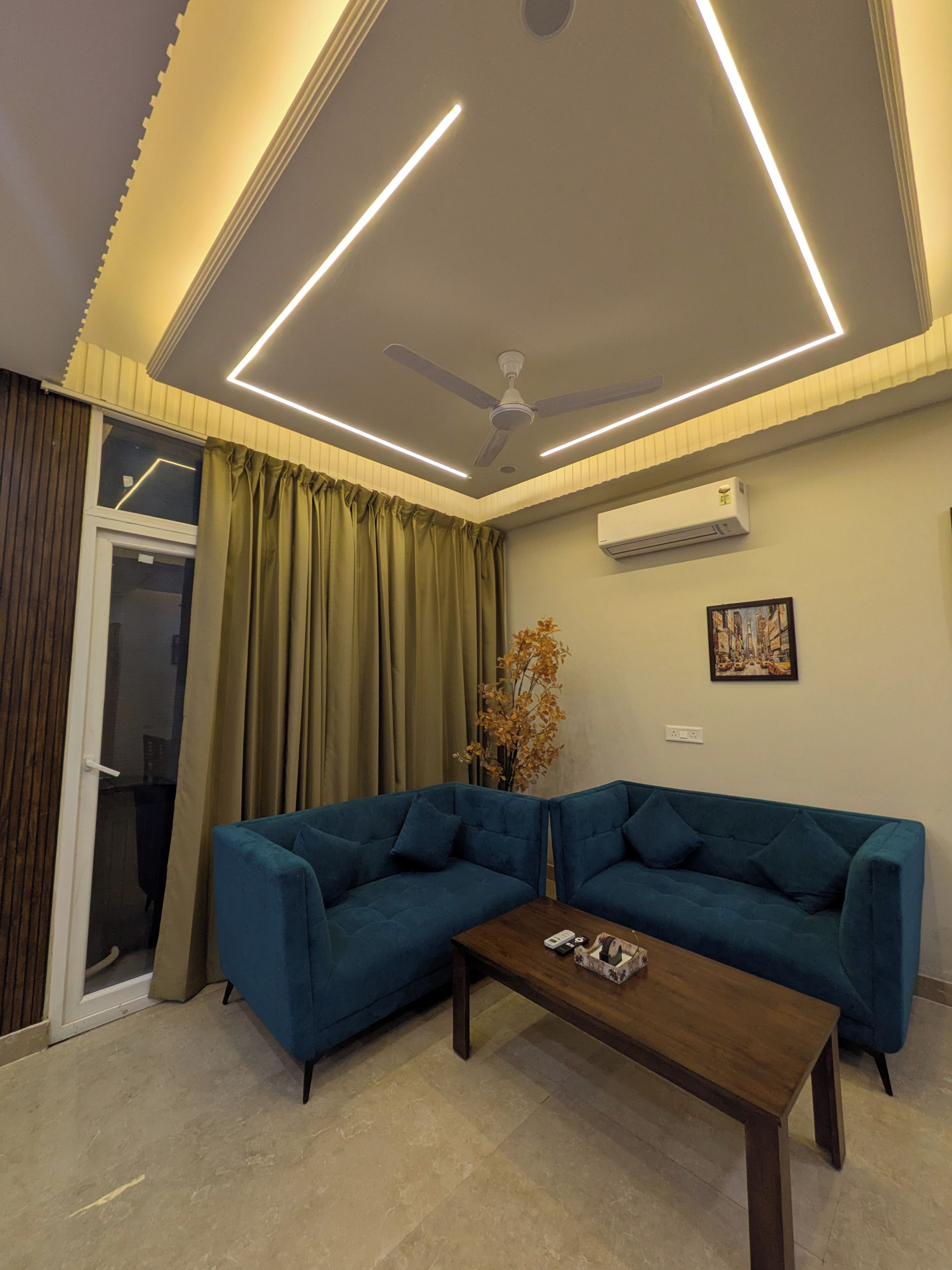 A modern living room with a sectional sofa, a coffee table, a ceiling fan, recessed lighting, and a window with curtains.