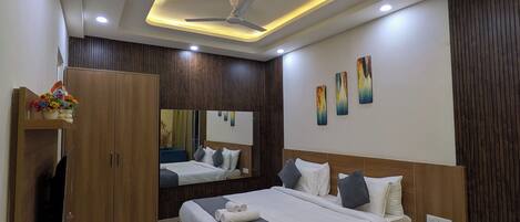 A modern bedroom with a bed, bedside tables, a wardrobe, a mirror, and a ceiling fan.