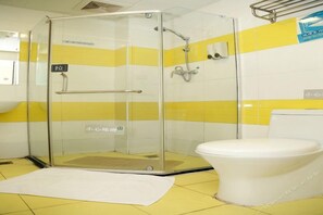 A bathroom with a glass-enclosed shower, a white toilet, and yellow and white tiled walls. - 7 Days Inn (Miyun)