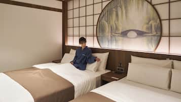 A hotel room with two beds, a large painting on the wall, and a nightstand with a lamp.