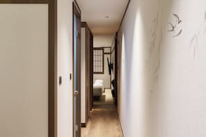 A hotel hallway with a bed, a window, and a door. - Stay Passport Kinosaki Ryokan Daejeon Yucheon by Anuk (Daejeon)