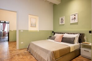 A bedroom with a bed, nightstands, and artwork on the walls. - Casa Torta by Maison Florence (Florence)