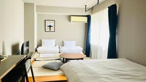 A hotel room with a bed, a desk, a chair, a small table, and a window with curtains. - Alphabed Hakata Comfort (Fukuokashi,Hakataku,Hakataekimae)