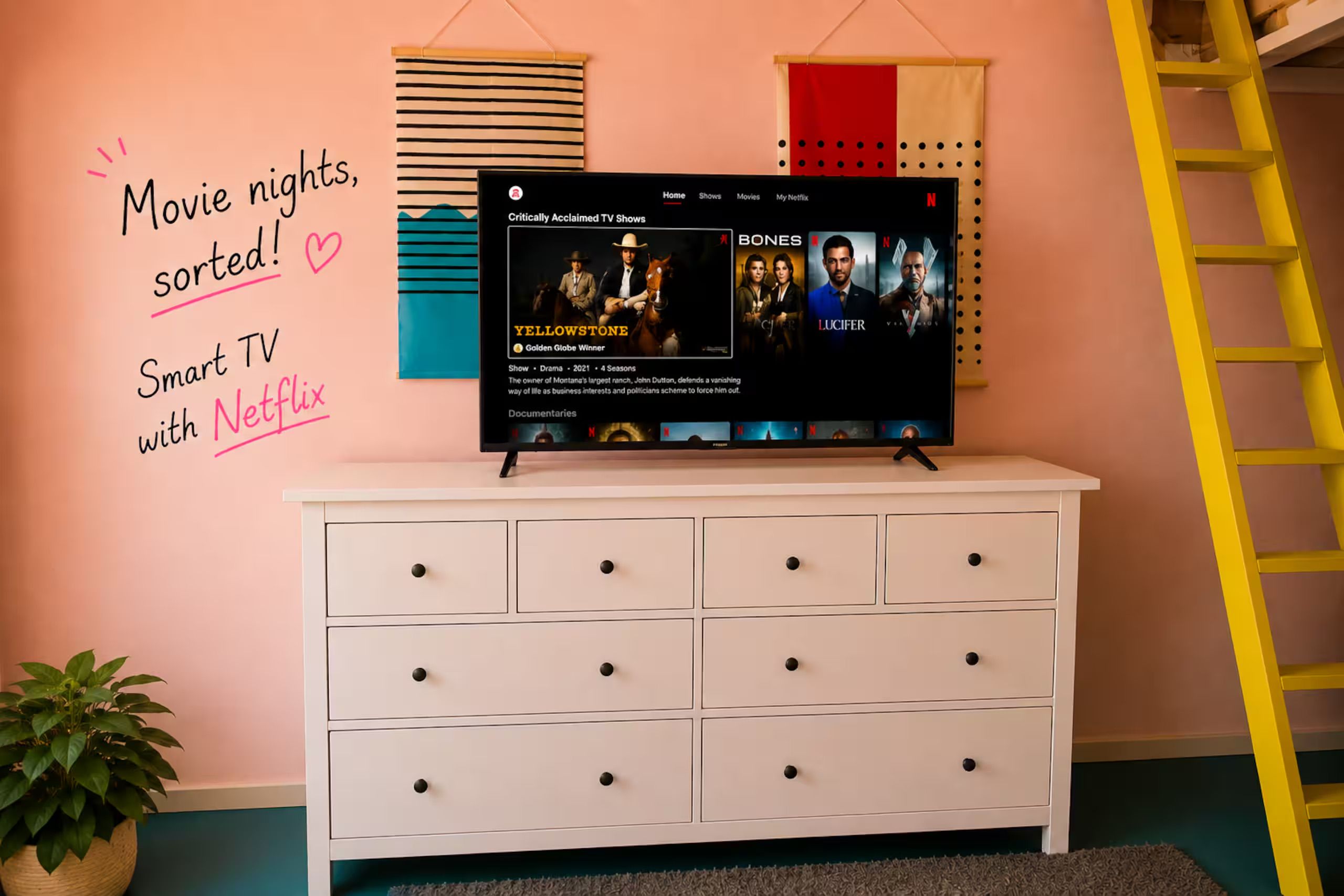 A television on a white dresser with a wall sign above it.