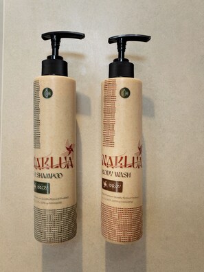 Two bottles of NAKLUNA body wash and shampoo with pump dispensers, placed on a flat surface. - Breezy North Pattaya (Pattaya)