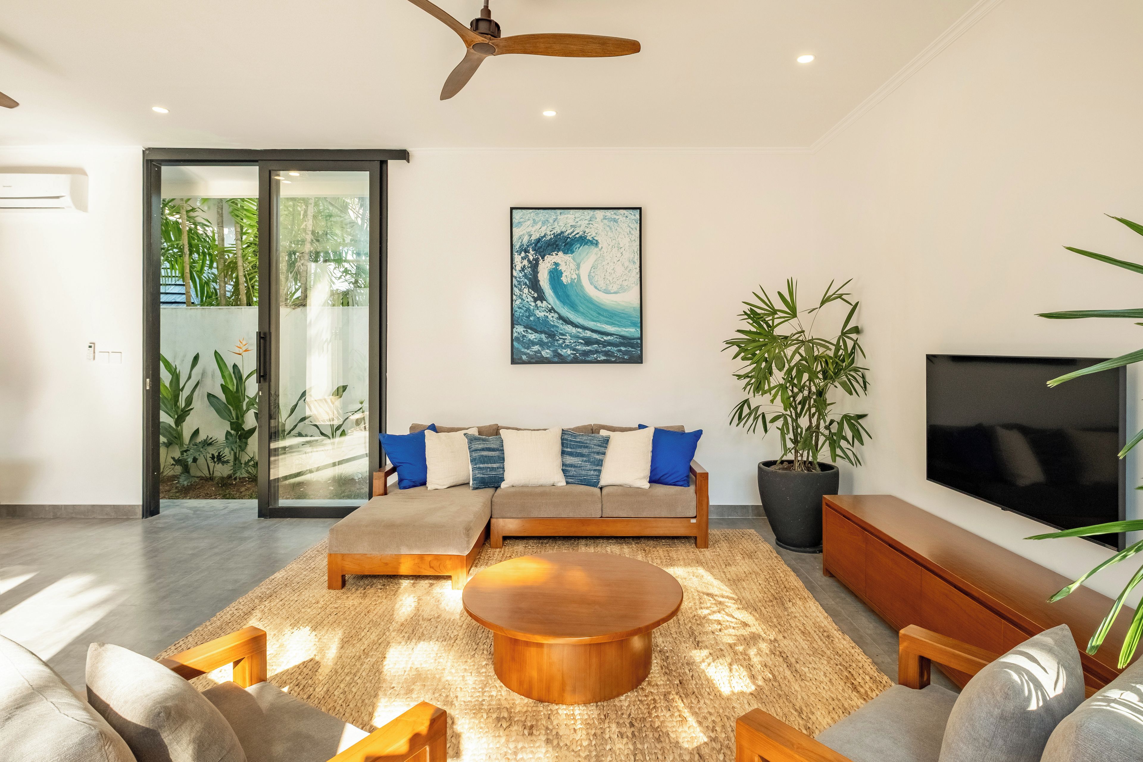 A modern living room with a sofa, coffee table, and TV.