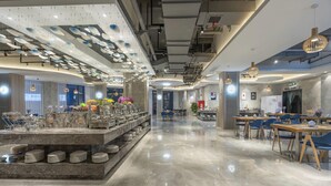 A modern hotel lobby with a marble reception desk, seating areas, and a buffet. - Lavande Hotel (Ganzhou)